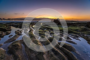 Colorful sunset at El Confital beach, La Isleta peninsula, Gran Canaria, Spain. photo