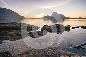 Sunset in El Nido, beautiful Cadlao island and low tide with surface reflection in foreground. Palawan island, Philippines