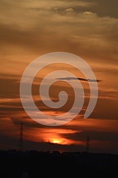 Sunset and electrical pylons, tropical sunset with dark clouds