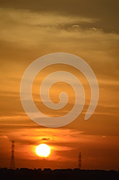 Sunset and electrical pylons, tropical sunset with dark clouds