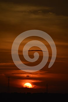 Sunset and electrical pylons, tropical sunset with dark clouds