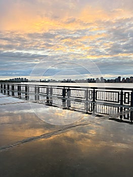 Sunset on the embankment after the rain. Reflection of the sky in the wet pavement, Kazan, Russia