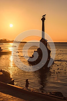 Sunset on embankment of Sevastopol. Monument to sunken ships against the sun. Sevastopol, Crimea
