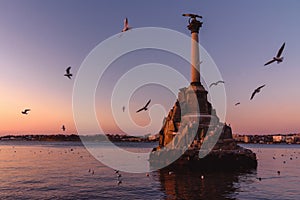 Sunset on embankment of Sevastopol. Monument to sunken ships against the sun. Sevastopol, Crimea