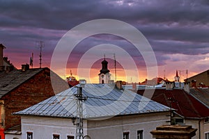 Sunset evening sky pink clouds of the roof of the houses of Uzhhorod city, Ukraine
