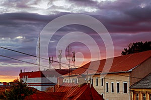 Sunset evening sky pink clouds of the roof of the houses of Uzhhorod city, Ukraine