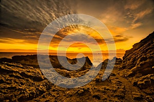 Sunset on the extreme rocky foreshore at Cape Palliser Wairarapa New Zealand