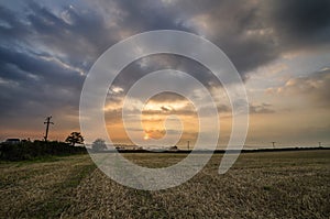 Sunset in farm fields with beautiful cloudy sky, Cornwall, UK