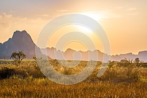 Sunset at the field with limestone mountain range