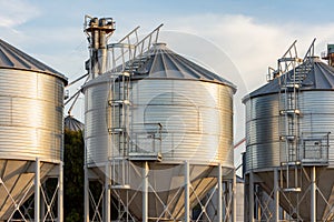 Sunset in the field. Silos for grain storage