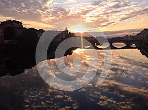 Sunset in Florence with beautiful sky reflections in Arno