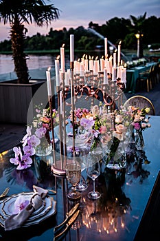 Sunset. Flowers. Candles. Wedding decoration. Floral arrangements