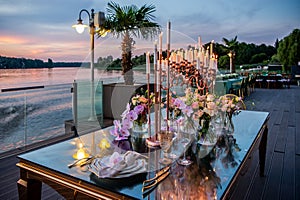 Sunset. Flowers. Candles. Wedding decoration. Floral arrangements