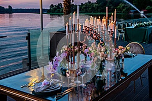 Sunset. Flowers. Candles. Wedding decoration. Floral arrangements