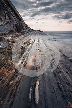 Sunset at the Flysch geological coastline, with Flysch formations in Zumaya in the Basque Country, Spain photo