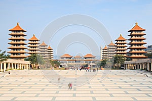 Sunset at Fo Guang Shan buddist temple of Kaohsiung, Taiwan with many tourists walking by.