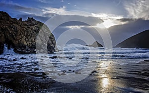 Sunset with Fog Surf and Rocks on California Beach