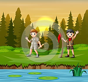 Sunset at forest background with a scout boys