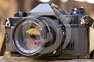 Sunset in the forest reflected in analog film camera lens