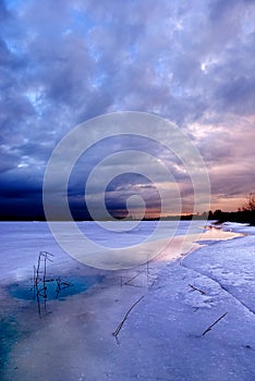 Sunset by a frozen lake