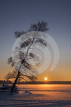 Sunset on a frozen lake. Winter landscape