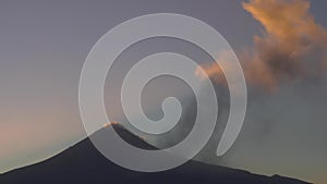 Sunset fumarole of the crater between the clouds of the Popocatepetl volcano in Mexico