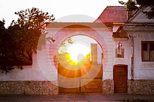 Sunset through the gate of an old house