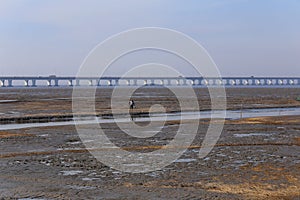 The sunset glow, the world's longest bridge have vehicles in traffic