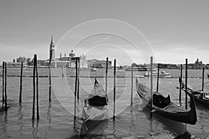 At sunset a Gondolas parking is a traditional, flat-bottomed Venetian rowing boat,