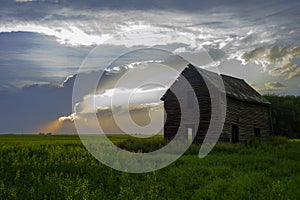 Abandoned old farm house in the prairies sunset photo