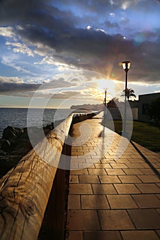 Sunset in Gran canary by the sea in a walking path way.