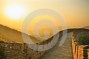 Sunset on the great wall of China, the air is saturated with smo