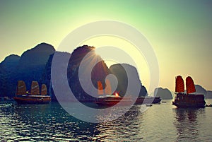 Sunset in Halong Bay with sailing junks