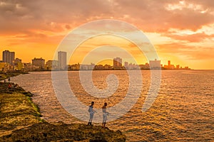 Sunset in Havana with fishermen on the foreground