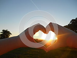 Sunset in heart hands