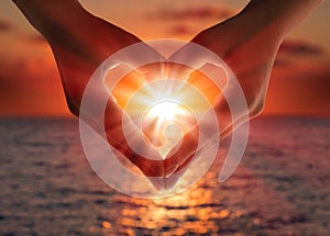 Sunset in heart hands