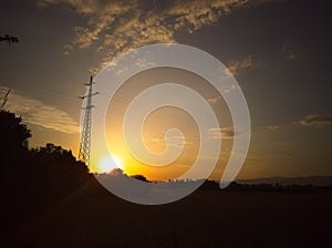 sunset with high tension posts