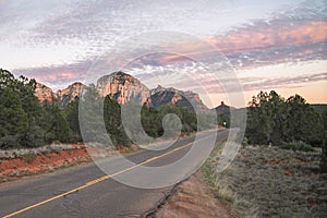 Sunset on highway with view of Sedona red rock formations in Arizona, USA