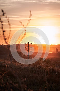 Sunset hills with telephone or power line poles