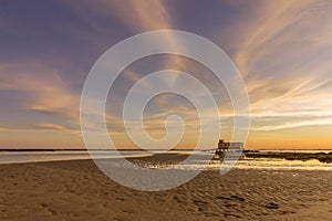 Sunset and historic life-guard building at Fuseta fishing town, Algarve.