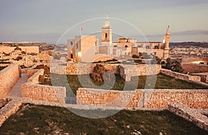 Sunset at historical Gozo island. Towers of the Cittadella, 16th century fort at evening time. Malta country photo
