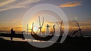 Sunset at Hokitika beach with clouds and golden sky on the South Island of New Zealand.