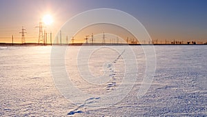 Sunset on the horizon of the winter field