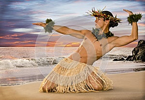 A sunset hula on the beach with a male hula dancer in traditional costume.