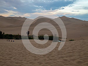 Sunset at Ica desert, small oasis surrounded by sand