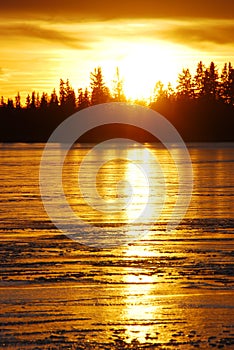 Sunset on the ice lake