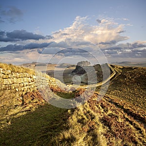 Sunset illuminates Hadrian`s Wall in Northumberland, England photo