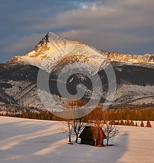 Sunset illuminates the mountain tops and the beautiful winter landscape.