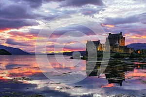Sunset image of sky reflected in Loch Duich with Eilean Donan Castle, Scotland, United Kingdom