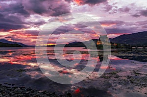 Sunset image of sky reflected in Loch Duich with Eilean Donan Castle, Scotland, United Kingdom